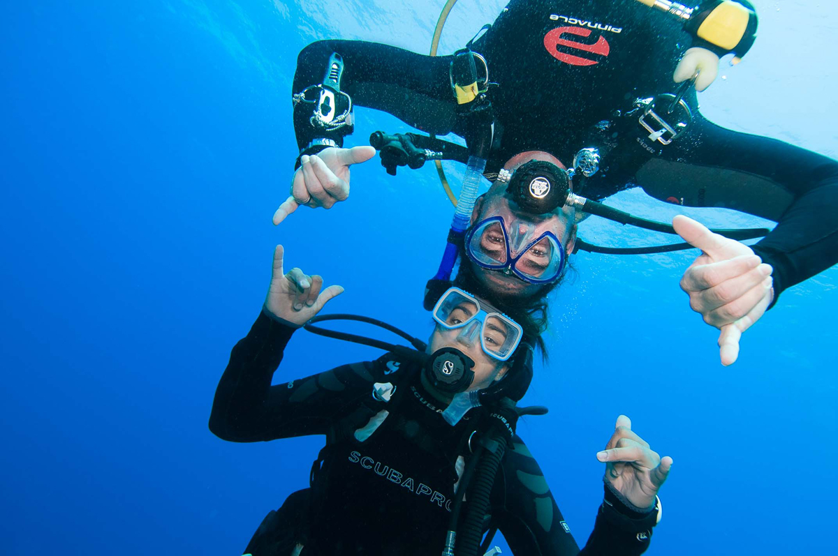 photo of two divers greeting the photographer
