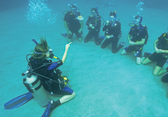 photo of instructor underwater with scuba students