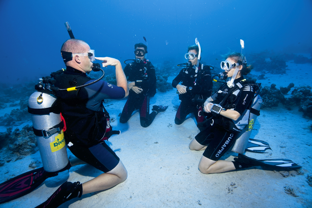 photo of instructor under water with scuba students